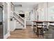 Open-concept layout with sleek hardwood flooring, a modern staircase, and elegant lighting at 103 Claremont Way, Mooresville, NC 28117