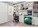 Well-lit home office with built-in bookshelves, a spacious desk, and comfortable seating, perfect for productivity at 103 Claremont Way, Mooresville, NC 28117