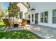 Cozy backyard patio with stylish seating, a lush lawn, and mature trees, creating a serene outdoor retreat at 103 Claremont Way, Mooresville, NC 28117