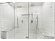 Luxurious tiled shower with dual shower heads and built-in marble benches for ultimate relaxation at 103 Claremont Way, Mooresville, NC 28117