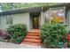 Front entry with brick steps, lush greenery, and unique window design at 109 Canterbury Ln, Matthews, NC 28104