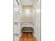 Hallway nook with a vanity, granite countertop, wooden floor, and access to the bathroom at 109 Canterbury Ln, Matthews, NC 28104
