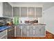 Kitchen features include granite countertops, gray cabinets, stainless steel appliances, and wood flooring at 109 Canterbury Ln, Matthews, NC 28104