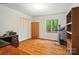 Office with wood floor, white walls, and a window with a view of trees, and treadmill at 109 Canterbury Ln, Matthews, NC 28104