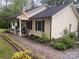 Charming home with a covered front porch, tidy landscaping, and a brick walkway leading to the entrance at 109 Wilson Acres Dr, Kings Mountain, NC 28086