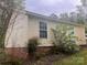 View of the home's exterior, with visible brick foundation and surrounding greenery at 109 Wilson Acres Dr, Kings Mountain, NC 28086