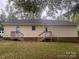 Back of the home showcasing dual entrances and a well-maintained yard, blending functionality with outdoor charm at 109 Wilson Acres Dr, Kings Mountain, NC 28086