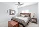 Cozy bedroom boasts a ceiling fan, matching lamps, and a decorative mirror at 11346 Olde Turnbury Ct, Charlotte, NC 28277