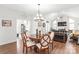 Open dining room with chandelier, hardwood floors, adjoining living room, and elegant decor at 11346 Olde Turnbury Ct, Charlotte, NC 28277
