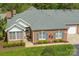 Aerial view of a well maintained brick home with manicured lawn and attractive landscaping at 11346 Olde Turnbury Ct, Charlotte, NC 28277