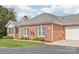 Brick home with a well-kept lawn, charming shutters, and an attached garage at 11346 Olde Turnbury Ct, Charlotte, NC 28277