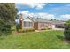 Beautiful brick home with well-maintained lawn and lush landscaping, showcasing classic charm at 11346 Olde Turnbury Ct, Charlotte, NC 28277