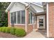 Inviting front entrance with large windows and a decorative door, surrounded by lush landscaping at 11346 Olde Turnbury Ct, Charlotte, NC 28277