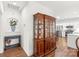 Hallway view featuring a beautiful display cabinet, small writing desk, and open kitchen at 11346 Olde Turnbury Ct, Charlotte, NC 28277