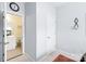 Hallway view leading to a bathroom with white cabinets and tile flooring at 11346 Olde Turnbury Ct, Charlotte, NC 28277