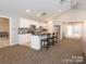 Modern kitchen area with stainless steel appliances and island seating for three at 11346 Olde Turnbury Ct, Charlotte, NC 28277