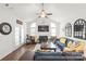 Bright living room with a fireplace, large windows, and a ceiling fan at 11346 Olde Turnbury Ct, Charlotte, NC 28277