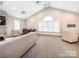 Bright living room with large windows, neutral tones, and a stone fireplace at 11346 Olde Turnbury Ct, Charlotte, NC 28277