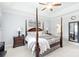 Well-lit main bedroom featuring a four-poster bed, bedside tables, lamps, and elegant decor at 11346 Olde Turnbury Ct, Charlotte, NC 28277