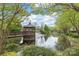 Beautiful pond with a gazebo and fountain, surrounded by lush greenery and mature trees at 11346 Olde Turnbury Ct, Charlotte, NC 28277