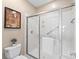 A glass-enclosed shower showcases a sleek design with a grab bar for added safety at 11346 Olde Turnbury Ct, Charlotte, NC 28277