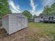 White storage shed stands in the yard of this charming home with a nice backyard and deck at 1159 Ragan Dr, Gastonia, NC 28054
