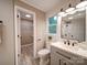 Well-lit bathroom featuring gray vanity, modern fixtures, and walk-in closet at 1159 Ragan Dr, Gastonia, NC 28054