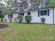 Charming white brick home with black shutters and well-maintained front yard landscaping at 1159 Ragan Dr, Gastonia, NC 28054