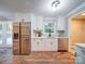 Bright, updated kitchen with stainless steel appliances, white cabinets, and hardwood floors at 1159 Ragan Dr, Gastonia, NC 28054