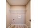 A small laundry area with a wire shelf and utility hookups at 1159 Ragan Dr, Gastonia, NC 28054