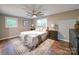 Comfortable main bedroom featuring a ceiling fan, large window, and wood flooring at 1159 Ragan Dr, Gastonia, NC 28054