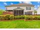Expansive backyard features a patio, deck, lush lawn, and mature landscaping at 130 Weeping Spring Dr, Mooresville, NC 28115