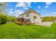 Beautiful backyard with a spacious deck, screened porch, lush lawn, and a two car side entry garage at 130 Weeping Spring Dr, Mooresville, NC 28115