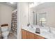 Bathroom with double sinks, vanity, toilet and shower featuring a decorative shower curtain at 130 Weeping Spring Dr, Mooresville, NC 28115