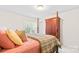 Cozy bedroom with natural light from the window and a beautiful armoire, offering a comfortable retreat at 130 Weeping Spring Dr, Mooresville, NC 28115