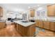 Open kitchen with an island, wooden cabinets, and hardwood flooring, great for cooking at 130 Weeping Spring Dr, Mooresville, NC 28115