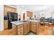 Spacious kitchen features wooden cabinets, a large island with a cooktop, and modern black appliances at 130 Weeping Spring Dr, Mooresville, NC 28115