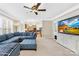 Open-concept living room with a blue sectional sofa, a fireplace, and a view into the kitchen at 130 Weeping Spring Dr, Mooresville, NC 28115
