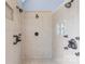Beautiful tiled shower with multiple shower heads and bronze fixtures, inside the main bathroom at 130 Weeping Spring Dr, Mooresville, NC 28115