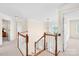 Bright foyer landing with hardwood staircase and chandelier, leading to the second story of the home at 130 Weeping Spring Dr, Mooresville, NC 28115