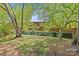 An expansive backyard with mature trees and privacy fence create a tranquil outdoor space at 1330 Dean St, Charlotte, NC 28216