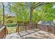 Wooden backyard deck overlooking lush greenery and mature trees, offering a tranquil outdoor space at 1330 Dean St, Charlotte, NC 28216