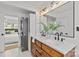 Bathroom boasts a double vanity, stylish fixtures, and a bedroom entrance, paired with a modern washer and dryer at 1330 Dean St, Charlotte, NC 28216
