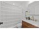Bathroom featuring modern vanity and fixtures with striped shower curtain at 1330 Dean St, Charlotte, NC 28216
