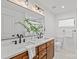 Well-lit bathroom featuring a dual sink vanity with sleek black fixtures and modern lighting above a large mirror at 1330 Dean St, Charlotte, NC 28216