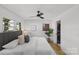 Light and airy bedroom features a ceiling fan and direct access to the laundry area at 1330 Dean St, Charlotte, NC 28216