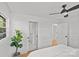 Bright bedroom with a ceiling fan, hardwood floors, and a lush green houseplant at 1330 Dean St, Charlotte, NC 28216
