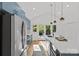 Well-lit kitchen with stainless steel appliances, blue cabinets, and a large island with bar seating at 1330 Dean St, Charlotte, NC 28216