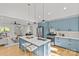 Open-concept kitchen featuring blue cabinets, a large island, and seamless access to the living room at 1330 Dean St, Charlotte, NC 28216