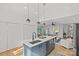 Kitchen island features a modern sink, stainless steel microwave, and eat-in barstools at 1330 Dean St, Charlotte, NC 28216